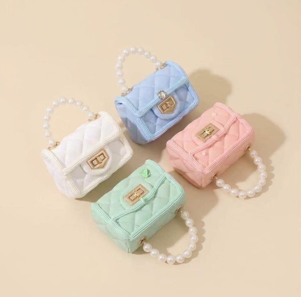 Four quilted mini bags in blue, white, pink and mint with pearl handles